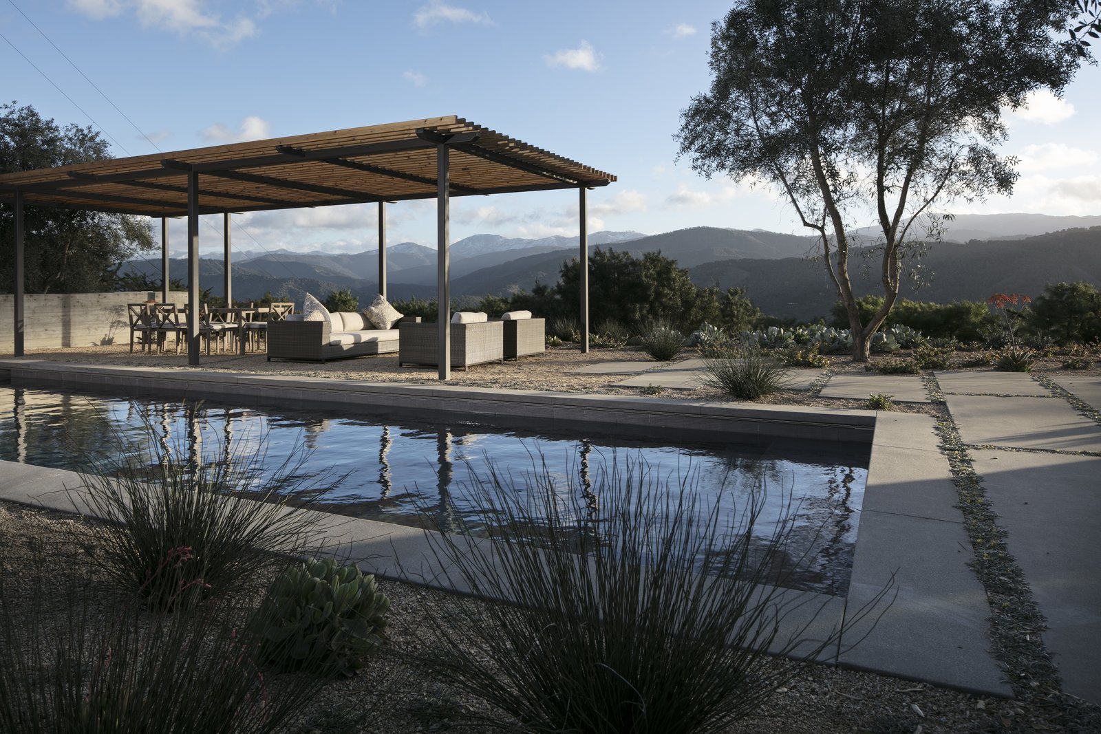 Looking over the pool to the outdoor living room and mountain views.